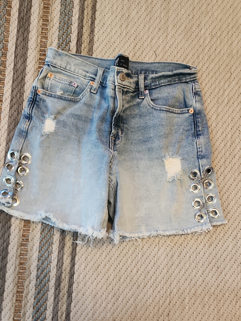 Light Blue Distressed Denim Shorts with Silver Eyelet Accents